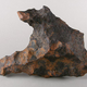 A mottled grey-brown space rock.